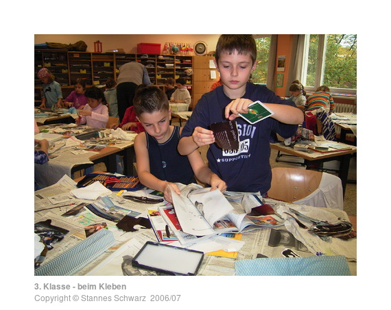 Two boys while cutting out and glueing